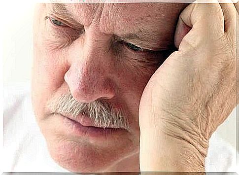 Man holding his head in his palm