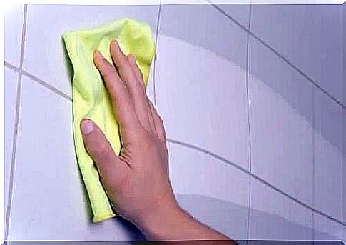 Woman cleaning tiles