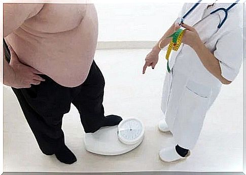 Doctor climbing an obese patient on the scales